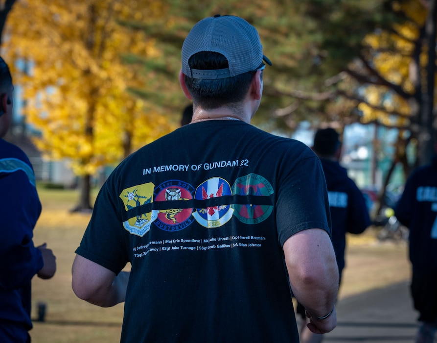 Participant run during a memorial 5K in honor of the GUNDAM 22 aircrew.