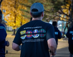 Participant run during a memorial 5K in honor of the GUNDAM 22 aircrew.