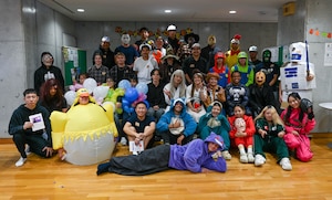 Service members and locals pose for a photo.