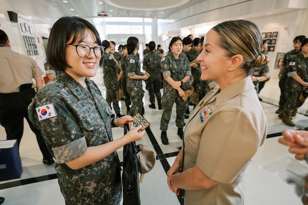 Capt. Patricia Butler, chief nursing officer for U.S. Naval Hospital Guam, presents a patch to Republic of Korea (ROK) Army Maj. Minji Woo, commandant of the ROK 2nd Cadet Company, during a visit by cadets to the hospital Nov. 14, 2025. The exchange recognized the continued partnership and professional collaboration between U.S. Navy medical personnel and ROK military nursing cadets. (U.S. Navy photo by Hospital Corpsman 1st Class Clien Lester Guico.)