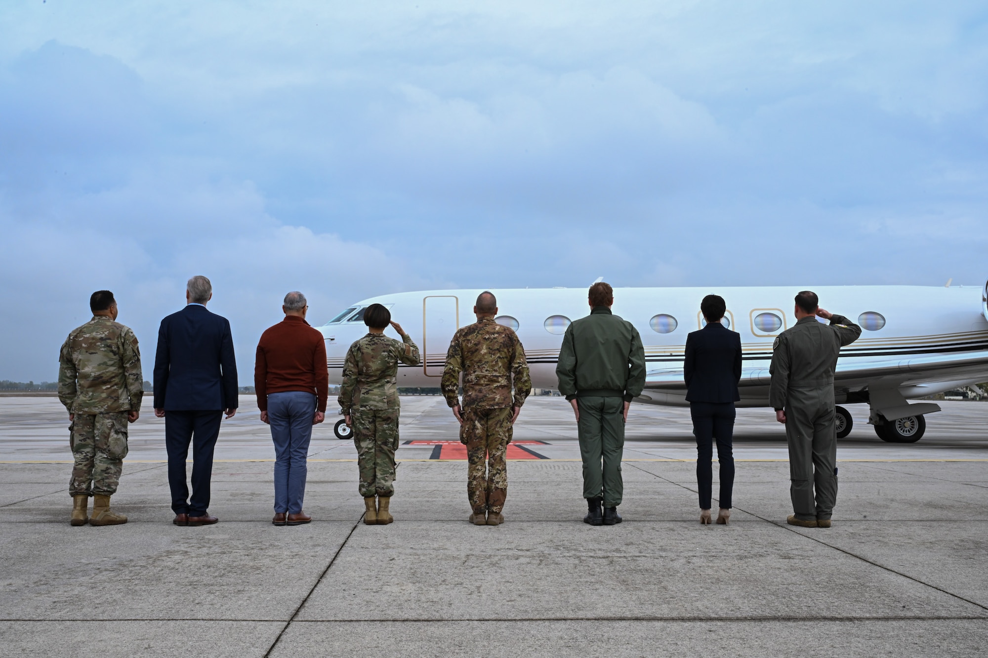 U.S. Air Force leaders salute the Honorable Tilman J. Fertitta, U.S. Ambassador to Italy as he arrives on his aircraft.