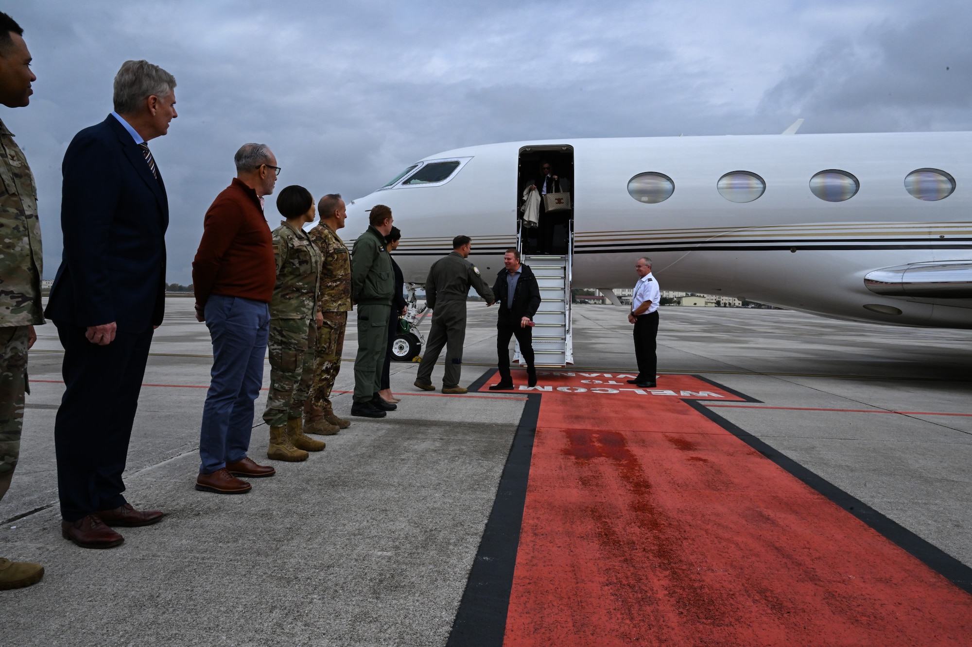Air Force leaders speak with the Honorable Tilman J. Fertitta, U.S. Ambassador to Italy as gets off an aircraft.