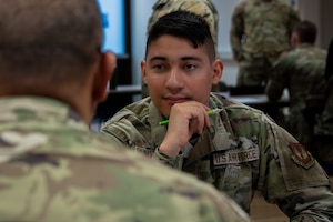 Airmen listen to Senior NCO, during mentorship session