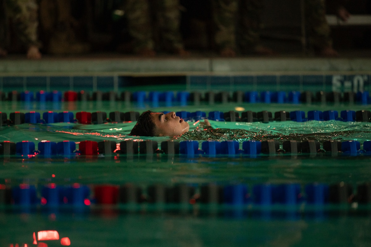 Airman Arnold Zuniga Leon, 99th Civil Engineering Squadron, participates in the 100-meter swim component of the German Armed Forces Proficiency Badge competition at Nellis Air Force Base, Nev., Nov. 12, 2025. Earning the badge signifies participants have met German military standards in physical fitness, marksmanship and first aid, with qualification levels awarded in bronze, silver or gold. (U.S. Air Force photo by Airman 1st Class Jennifer Nesbitt)