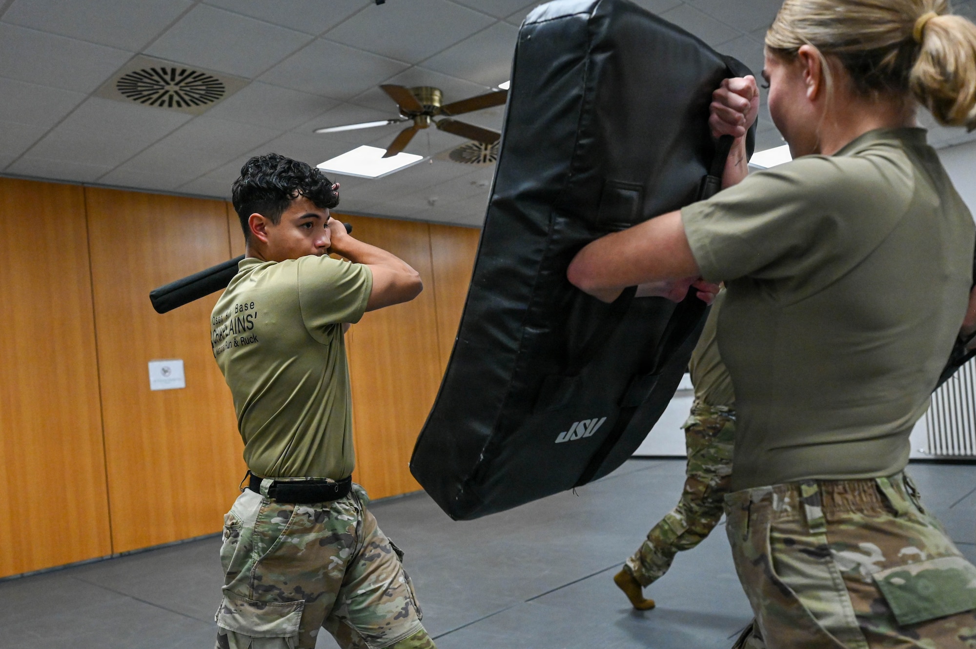 U.S. Air Force Senior Airman Tristan Salazar, left, and Airman Isabel Martinez, assigned to the 86th Security Forces Squadron, execute a baton exercise at Ramstein Air Base, Germany, 2025.