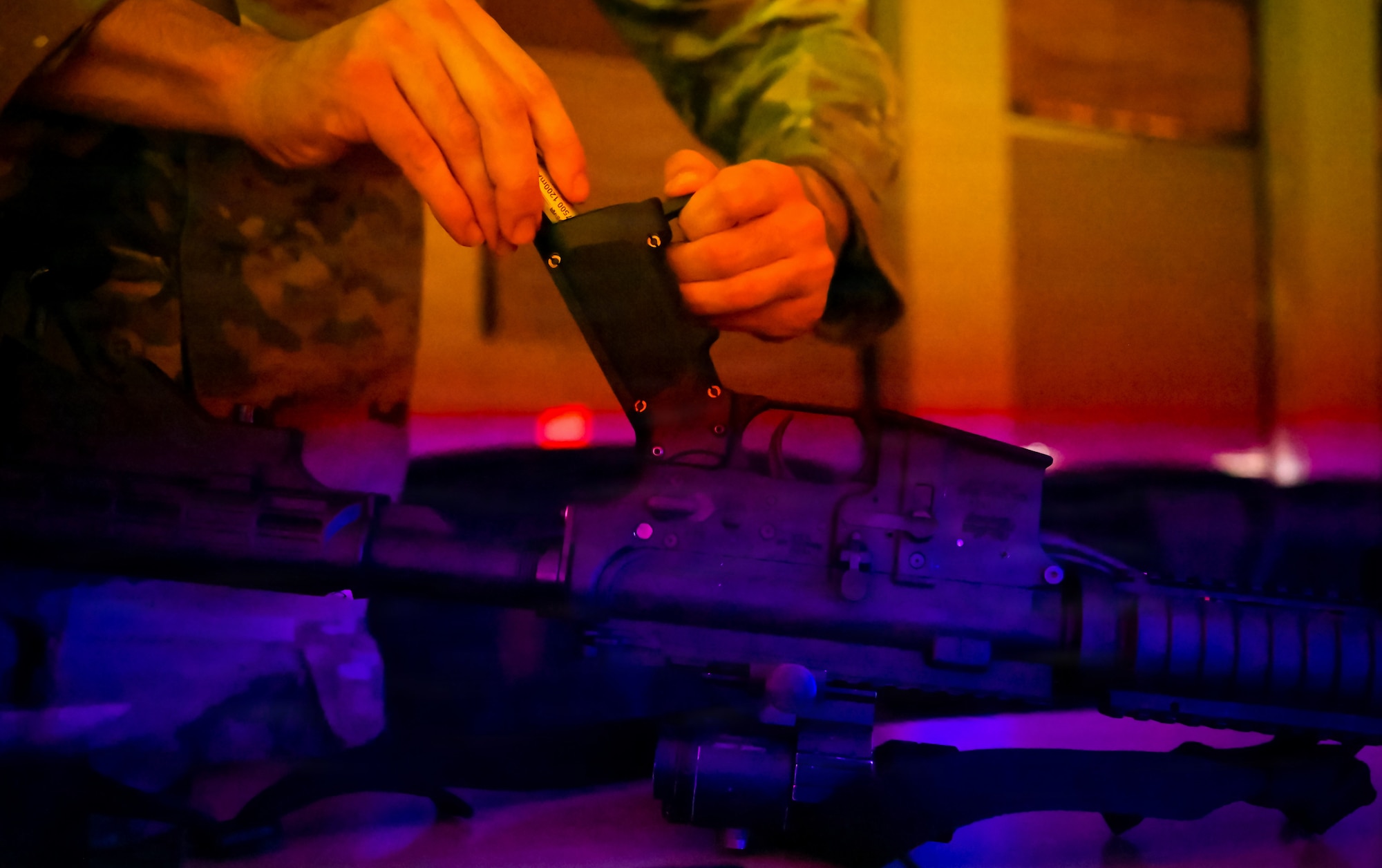 U.S. Air Force Senior Airman Alexandro Ochoa, 86th Security Forces training instructor, loads a battery into a model M16 rifle for training at Ramstein Air Base, Germany, Nov. 25, 2025.