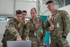 Maryland Air National Guard Maj. Luke Humphries, a cyber operator assigned to the 276th Cyberspace Operations Squadron, works together with cyber operators from the Romanian Cyber Command to conduct red team operations during the Saber Guardian 25 cyber exercise as part of DEFENDER 25, June 12, 2025, in Bucharest, Romania. Airmen from the Maryland Air National Guard and NATO counterparts from the Romanian Cyber Command who participated in red team cyber operations emulated adversarial cyber attacks in a simulated network and worked to identify weaknesses and vulnerabilities.



Demonstrating global deterrence and the U.S. Army’s ability to rapidly deploy U.S.-based combat power in Europe and the Arctic region alongside Allies and partners, DEFENDER 25 brings U.S. troops together with forces from 29 Allied and partner nations to build readiness through large-scale combat training from May 11 to June 24, 2025. DEFENDER 25 increases the lethality of the NATO alliance through large-scale tactical training maneuvers and long-range fires, build unit readiness in a complex joint, multinational environment, and leverages host nation capabilities to increase the U.S. Army’s operational reach. During three large-scale combat training exercises — Swift Response, Immediate Response, and Saber Guardian — Ally and partner forces integrate and expand multi-domain operations capability, demonstrating combined command and control structures and readiness to respond to crisis and conflict. (U.S. Air National Guard photo by Staff Sgt. Laura Virtue)(This photo has been altered for security purposes by blurring out access badges.)