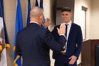 Airman Drini Gashi, a new Iowa National Guard recruit, recites the oath of enlistment, 132nd Air Wing Base, Des Moines, Iowa, Nov. 20, 2025.