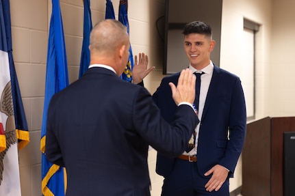 Airman Drini Gashi, a new Iowa National Guard recruit, recites the oath of enlistment, 132nd Air Wing Base, Des Moines, Iowa, Nov. 20, 2025.