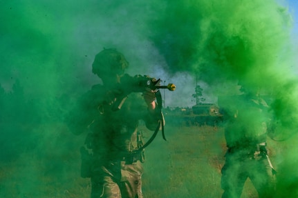 Airman walking through smoke