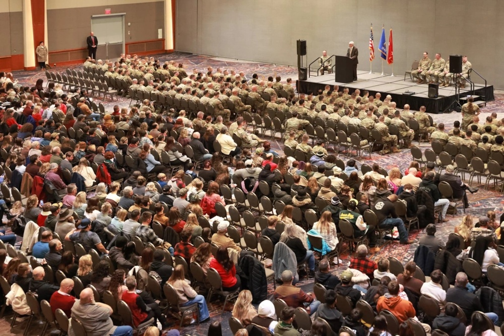 Wisconsin Gov. Tony Evers speaks to deploying members of the Wisconsin Army National Guard's 1st Battalion, 121st Field Artillery Regiment and their families during a formal send-off ceremony in Milwaukee, Wisconsin, Nov. 30, 2025. Soldiers assigned to the regiment's headquarters battery were recognized during the ceremony before departing to the U.S. Central Command area of responsibility to provide High Mobility Artillery Rocket System capabilities and work alongside their strategic partners in the region. (U.S. National Guard photo by Paul Gorman)