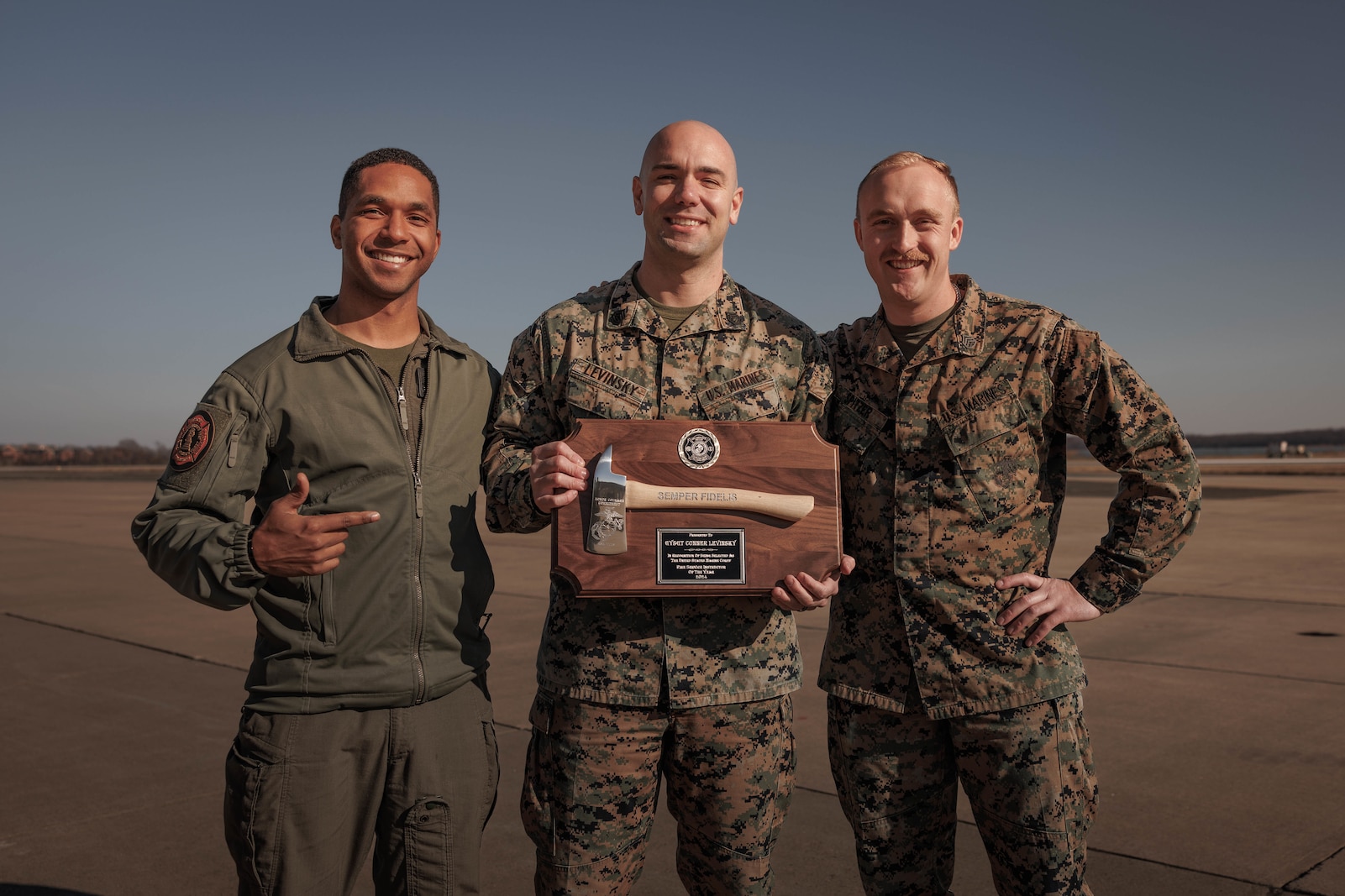 U.S. Marine Corps Gunnery Sgt. Kenny Jules, an expeditionary firefighting and rescue training chief, left, Gunnery Sgt. Conner Levinsky, the assistant chief of logistics, and Staff Sgt. Nicholas Spitzer, a crash fire and rescue captain, all with MCAF, pose for a photo during Levinsky’s award ceremony at MCAF on Marine Corps Base Quantico, Virginia, Dec. 3, 2025. Levinsky received the “USMC Fire Service Instructor of the Year” award recognizing his exceptional teaching abilities, his impact on student performance, and his contributions to the Marine Corps fire service community. (U.S. Marine Corps photo by Lance Cpl. Harleigh Faulk)