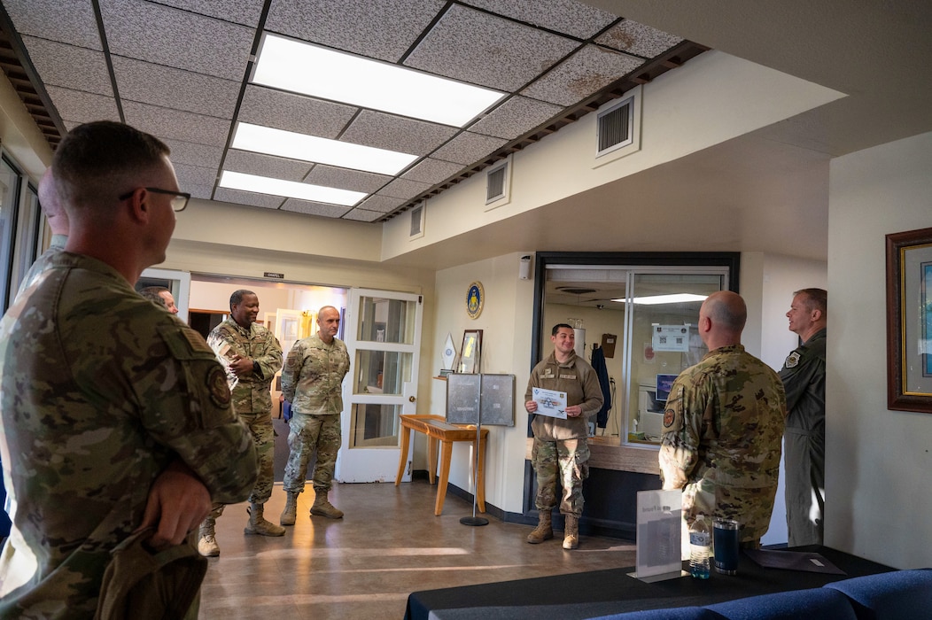 U.S. Air Force Senior Airman Joshua Reyes, 97th Air Mobility Wing (AMW) Chapel Office religious affairs airman, accepts his Airman of the Month award in the base chapel at Altus Air Force Base, Oklahoma, Sept. 29, 2025. Reyes was surprised by the award by the 97th AMW command team. (U.S. Air Force photo by Tech. Sgt. Hailey Haux)