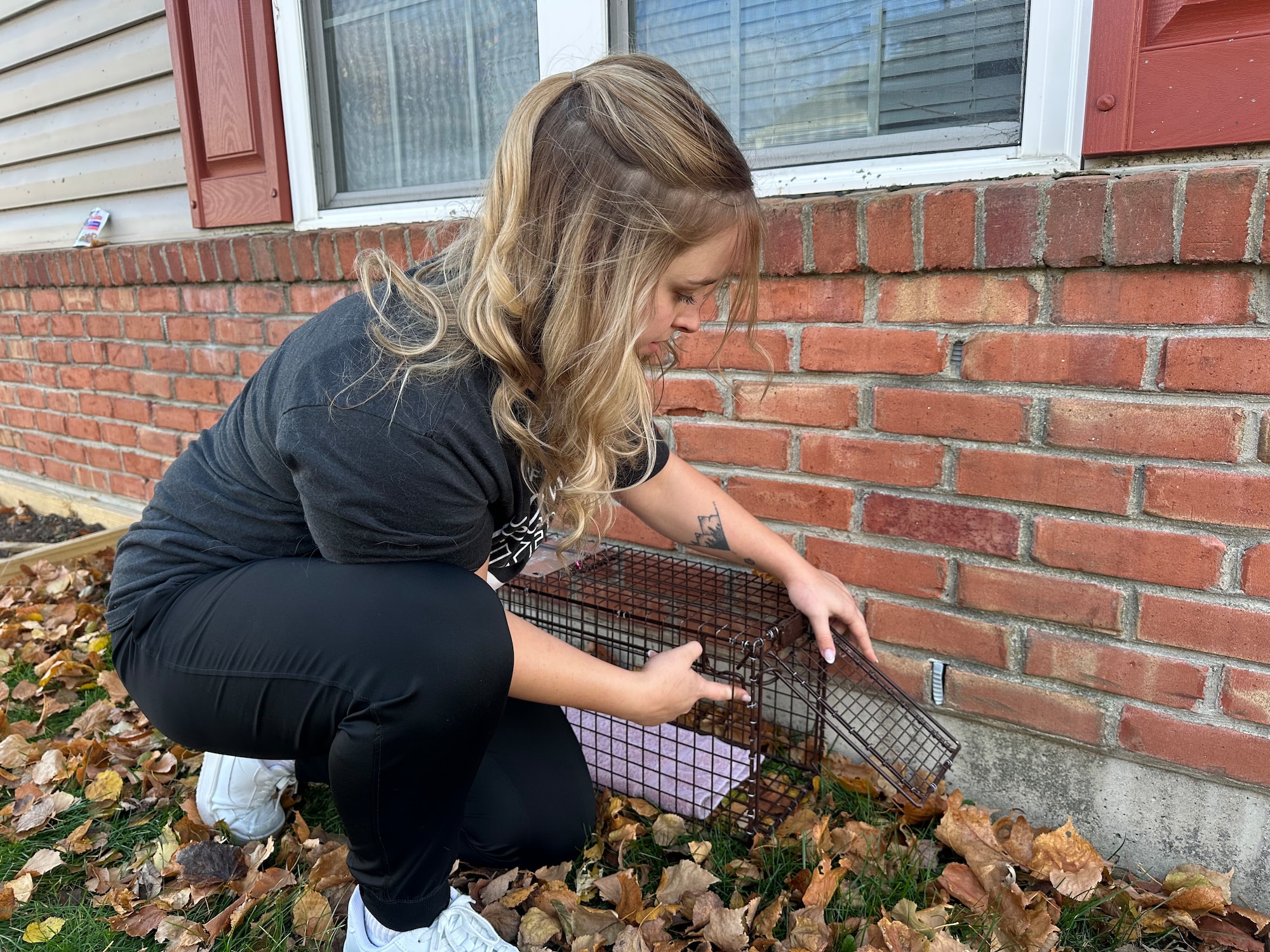 Capt. Alexandria Beckett sets up a trap for stray cats in a residential area of Dayton, Ohio.