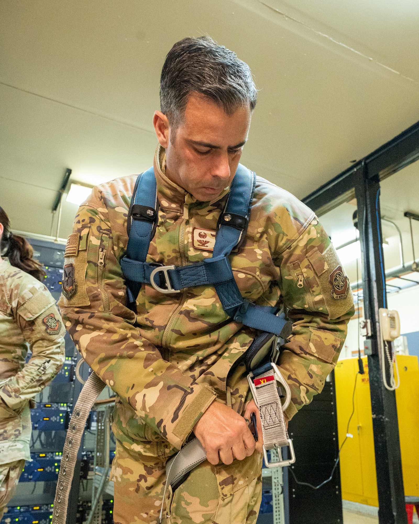 U.S. Air Force Col. Jamil Musa, 436th Airlift Wing commander, dons a safety harness during a Dover Duties tour at Dover Air Force Base, Delaware, Nov. 25, 2025. The tours afford the Dover AFB command team an immersive experience into the tasks completed by Airmen on a daily basis across the base. (U.S. Air Force photo by Mauricio Campino)
