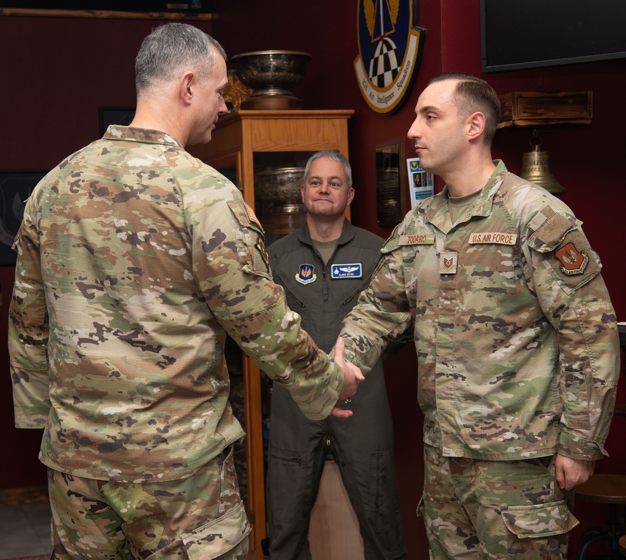 General shakes Airman's hand