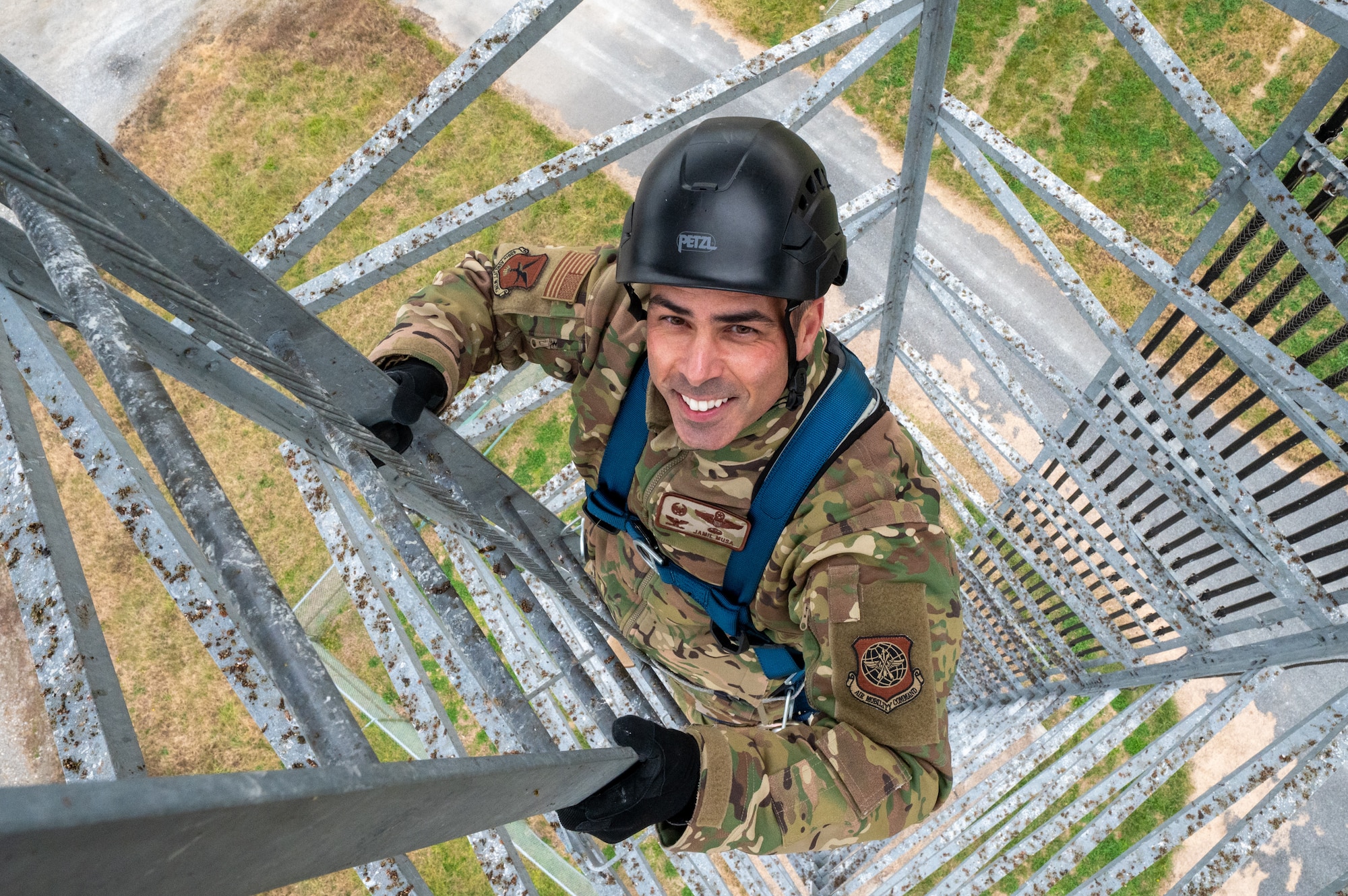 U.S. Air Force Col. Jamil Musa, 436th Airlift Wing commander, climbs a radio tower during a Dover Duties tour at Dover Air Force Base, Delaware, Nov. 25, 2025. During the tour, the Dover AFB command team visited radar airfield weather systems facilities and climbed a 60-foot radio tower. (U.S. Air Force photo by Mauricio Campino)