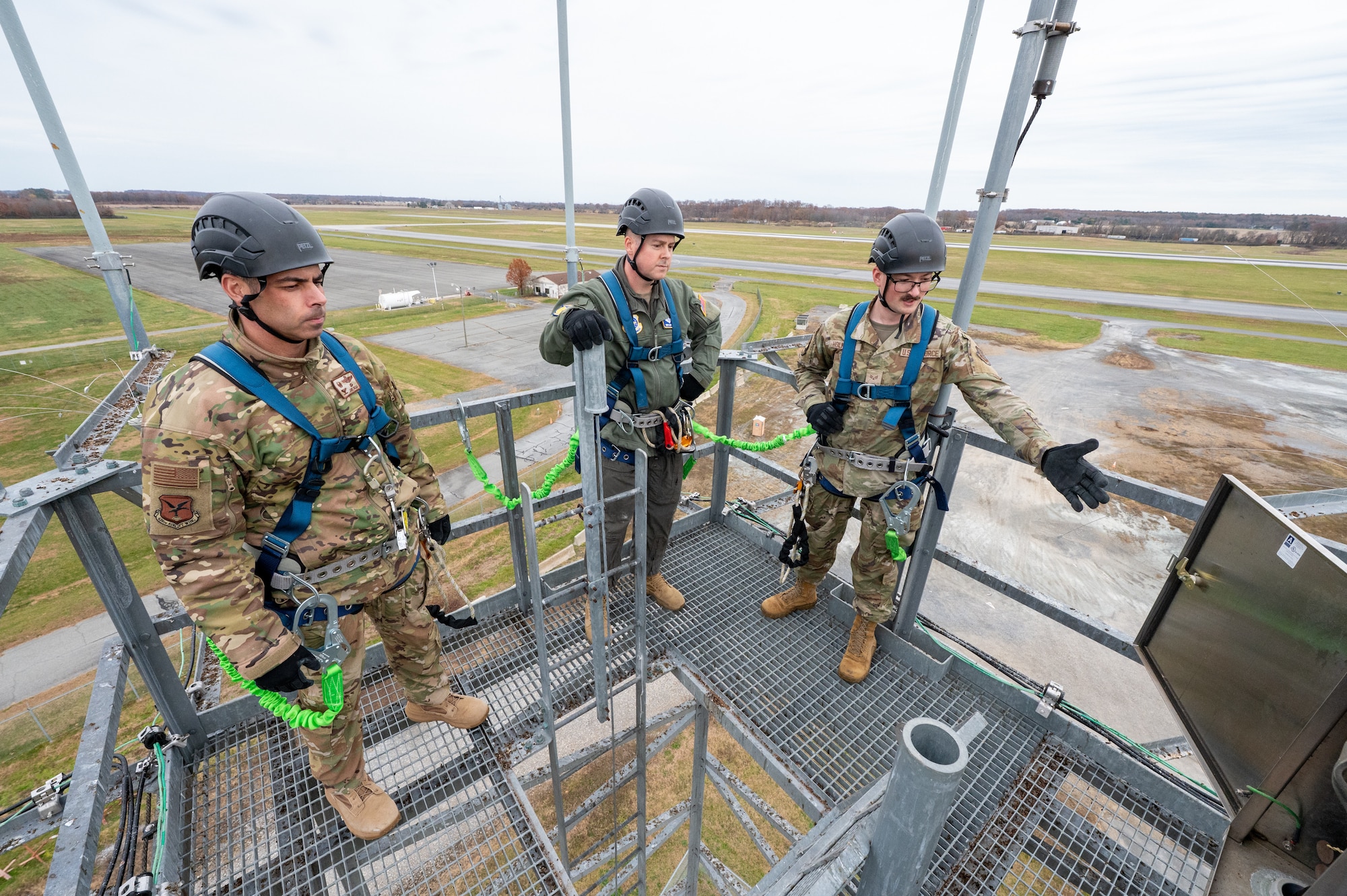U.S. Air Force Senior Airman Kyron Holmberg, right, 436th Operations Support Squadron radar airfield weather systems trainer, shows Col. Jamil Musa, 436th Airlift Wing commander, and Chief Master Sgt. Gary West, 436th AW interim command chief, how to perform routine maintenance on a radio tower during a Dover Duties tour at Dover Air Force Base, Delaware, Nov. 25, 2025. The command team took time during the tour to find out how certain processes can be improved. (U.S. Air Force photo by Mauricio Campino)