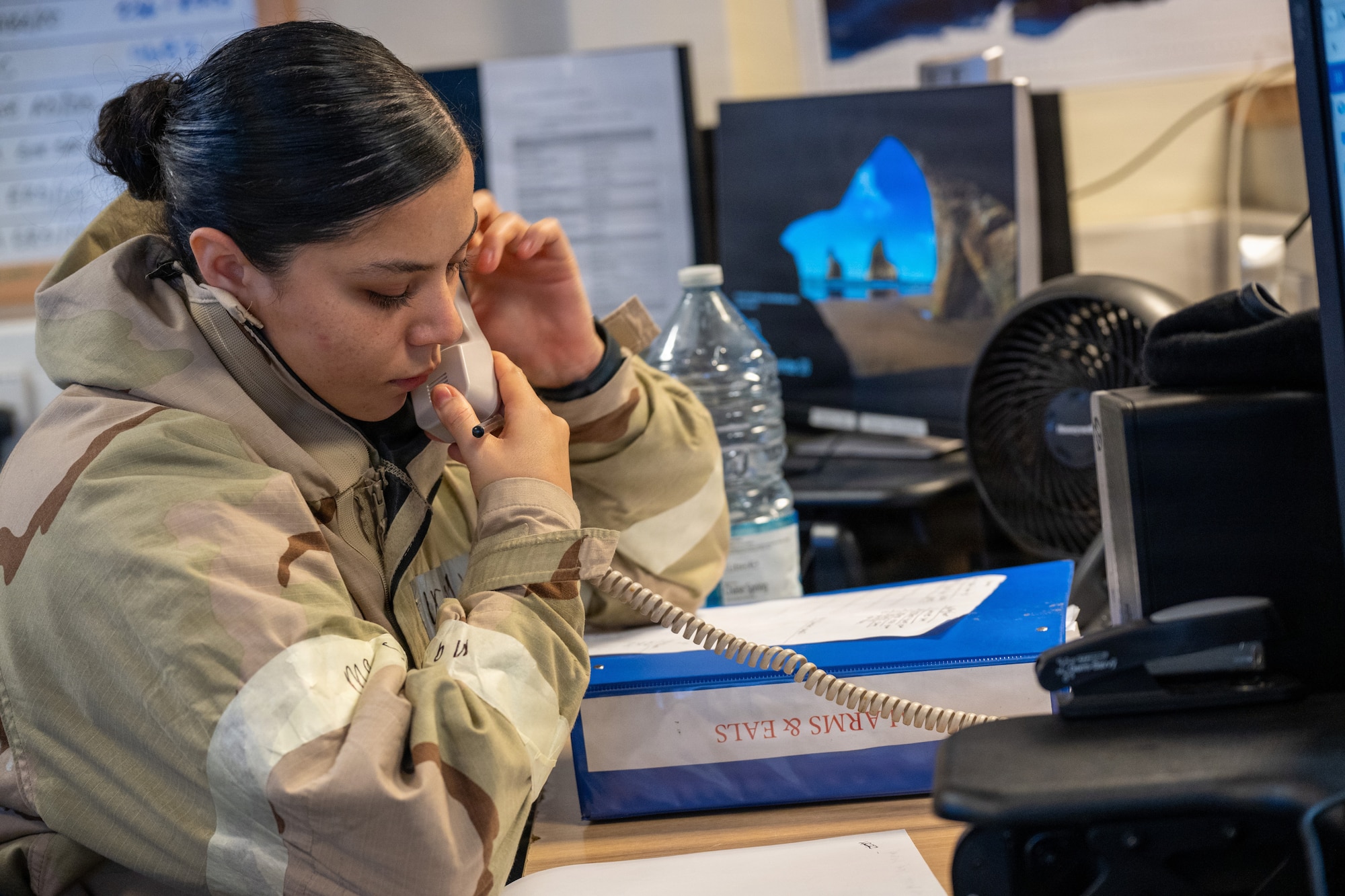 U.S. Air Force Senior Airman Cameryn Wood, 422nd Security Forces Squadron BDOC controller, answers a telephone