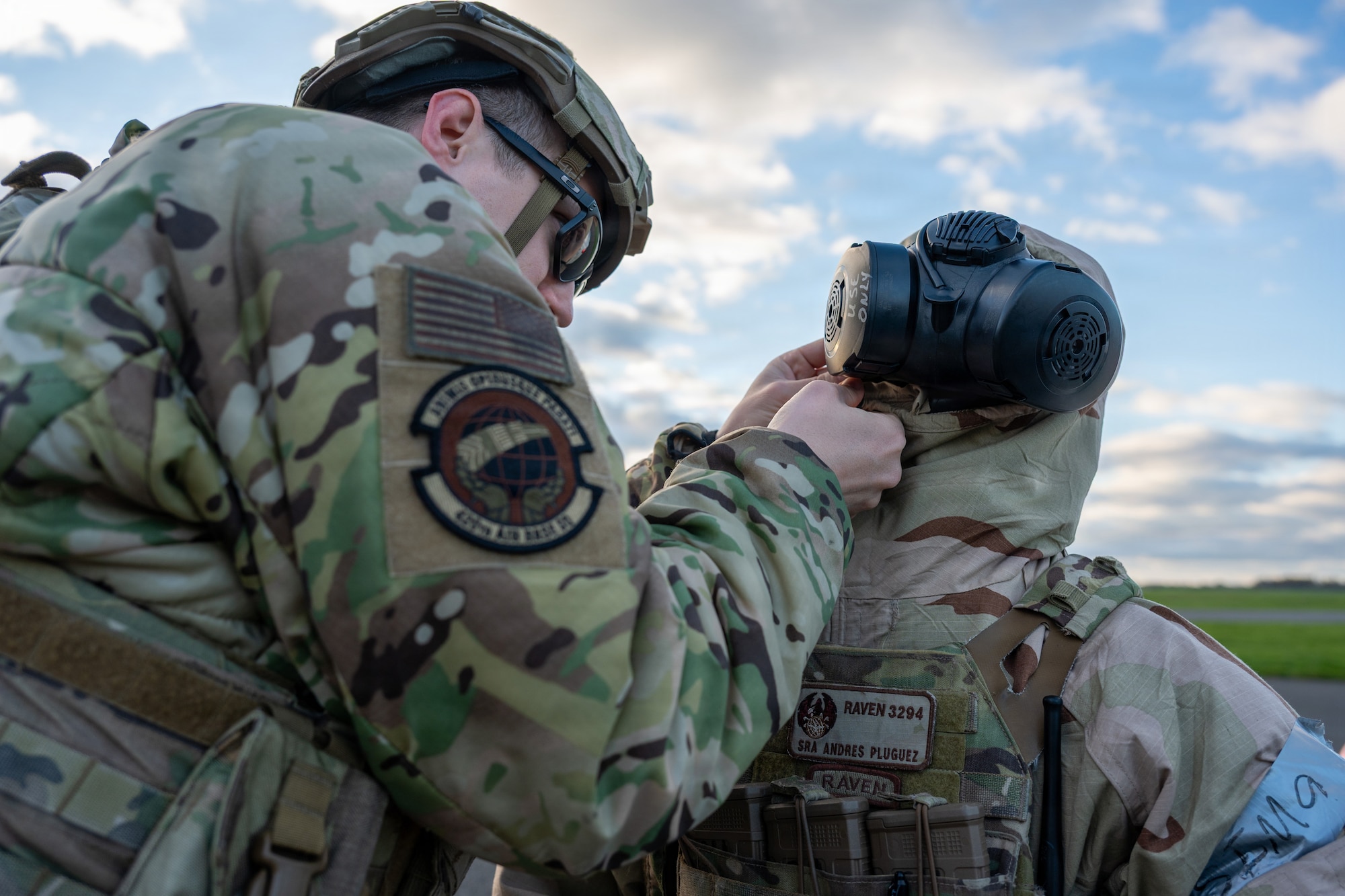 Pathfinders assist each other with donning mission-oriented protective posture (MOPP) gear