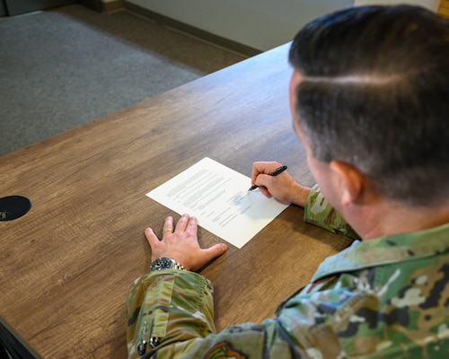U.S. Air Force Col. Clayton Rabens, Maxwell Medical Group commander, signs a base support agreement strengthening cooperation between the 42d ABW and newly established Maxwell Medical Group under the 359th Medical Wing. A support agreement ensures clear responsibilities, reliable services and uninterrupted mission support between the installation and its newest tenant unit. (U.S. Air Force photo by Senior Airman Evan Lichtenhan)