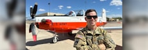 CW3 Ben Bailey poses in front of an aircraft