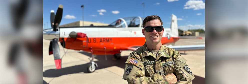 CW3 Ben Bailey poses in front of an aircraft