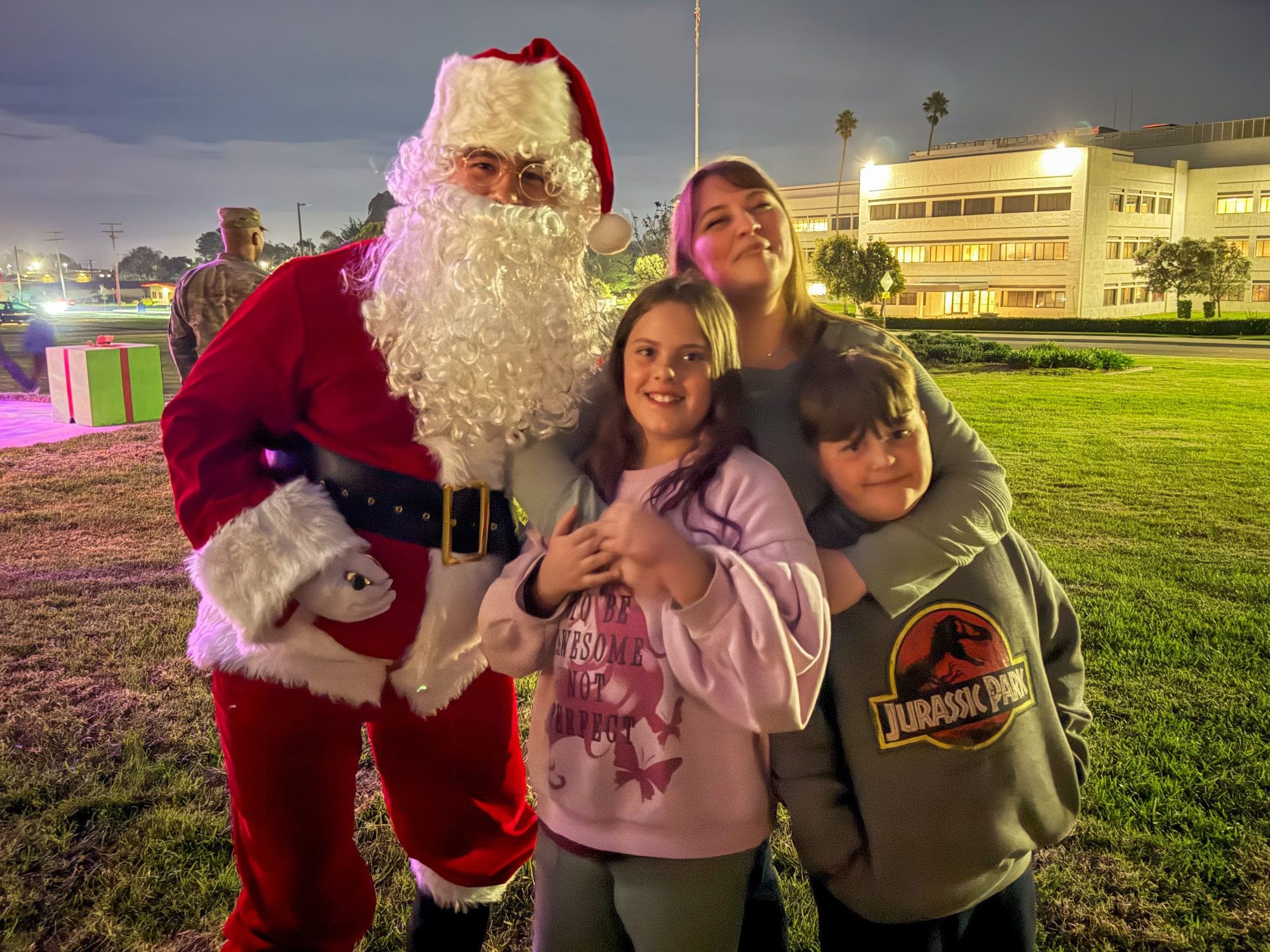 A Vandenberg SFB family poses with Santa Claus during the annual Holiday Tree Lighting Ceremony.