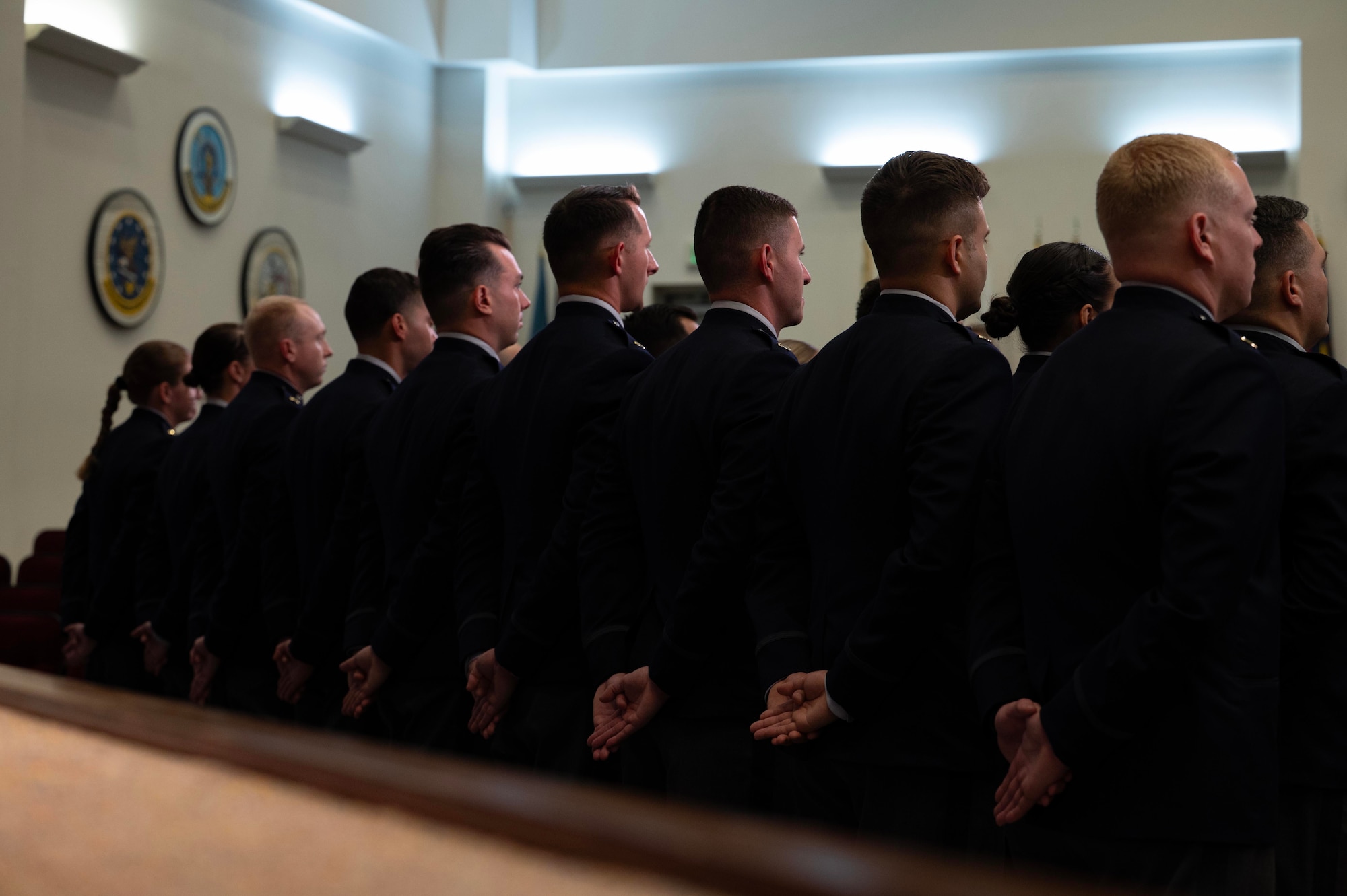 U.S. Space Force officer trainees stand in formation wearing their new service dress in preparation for Officer Training School graduation at Maxwell Air Force Base, Alabama, Dec. 4, 2025. One hundred officer trainees per year commission as Space Force Second Lieutenants through OTS, and 17 Guardians graduated in this week’s iteration of new officers. (U.S. Air Force photo by Tech. Sgt. Savannah L. Waters)