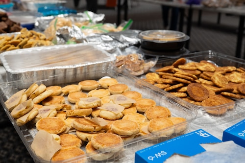 Cookies sit on a table during the first packaging day of the Cookie Caper at the Powell Event Center, Goodfellow Air Force Base, Texas, Dec. 2, 2025. Members from the 17th Training Wing partnered with the city of San Angelo and surrounding communities to provide cookies for all students and first-term service members stationed at Goodfellow. (U.S. Air Force photo by Senior Airman Brian Lummus)