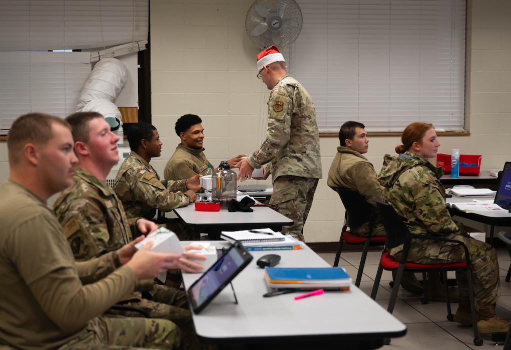 U.S. Air Force students attached to the 312th Training Squadron receive holiday cookies at Goodfellow Air Force Base, Texas, Dec. 4, 2025. With the help of the San Angelo community, Goodfellow AFB organized and orchestrated the annual cookie caper event, allowing many trainees and first-term military service members to receive cookies for the holidays. (U.S. Air Force photo by Airman 1st Class Maria Mota)
