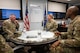 Chief Master Sgt. Chad W. Bickley sits at a table with Col. Tiffany L. Arnold and U.S. Air Force Chief Master Sgt. Anthony Anderson.