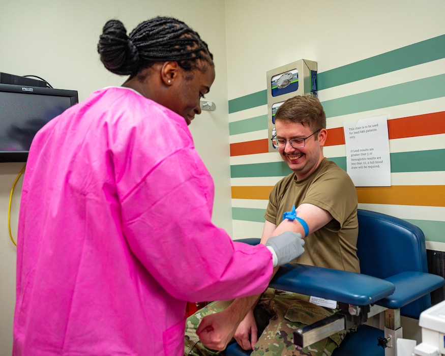 U.S. Air Force Senior Airman Evalyn McBryde (left), 56th Medical Support Squadron medical lab technician, prepares a patient for a blood draw, Nov. 20, 2025, at Luke Air Force Base, Arizona.