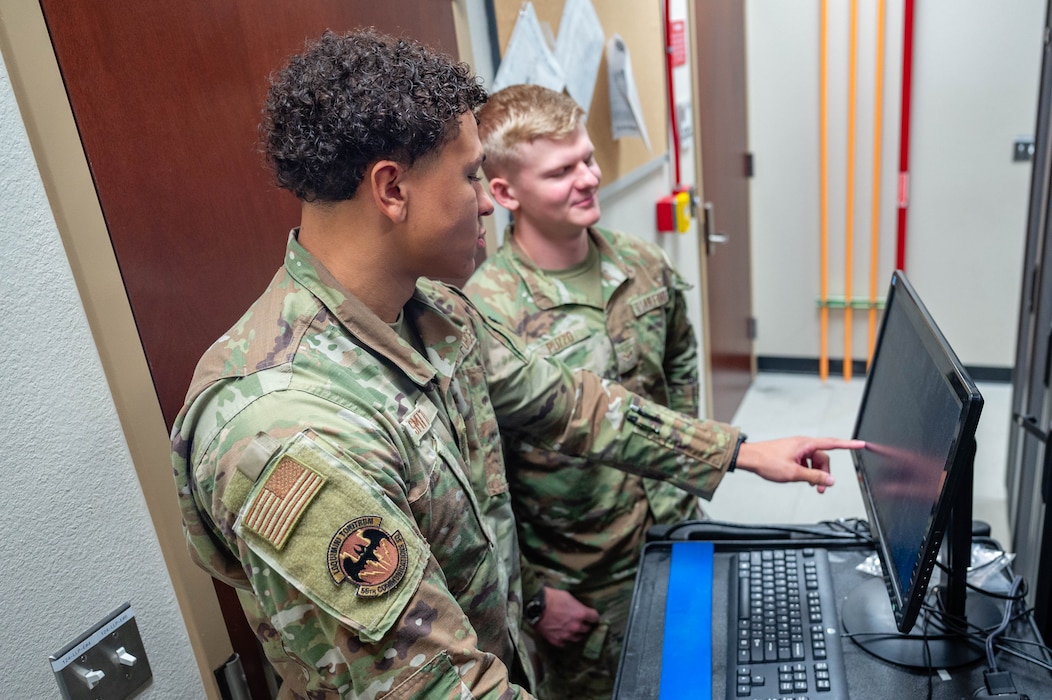 U.S. Air Force Airman 1st Class Devyn Smith (left), and Airman 1st Class Dominic Puzzo (right), both 56th Communications Squadron network systems operation technicians, work together to maintain a server, Oct. 1, 2025, at Luke Air Force Base, Arizona.