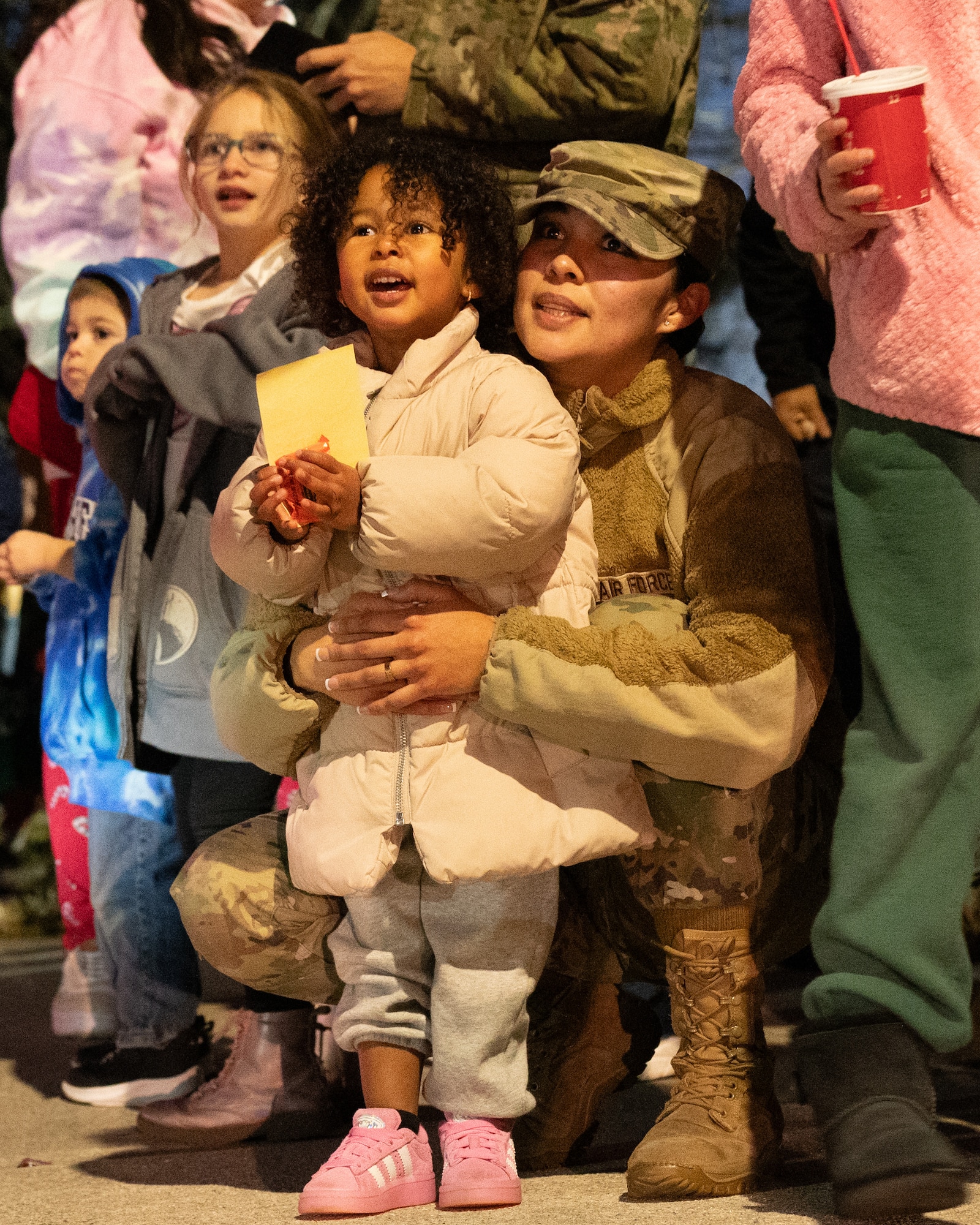 Team Dover families wait for the arrival of Santa Claus during the annual holiday parade at Dover Air Force Base, Delaware, Dec. 1, 2025. The annual celebration included food trucks and activities for children. (U.S. Air Force photo by Mauricio Campino)