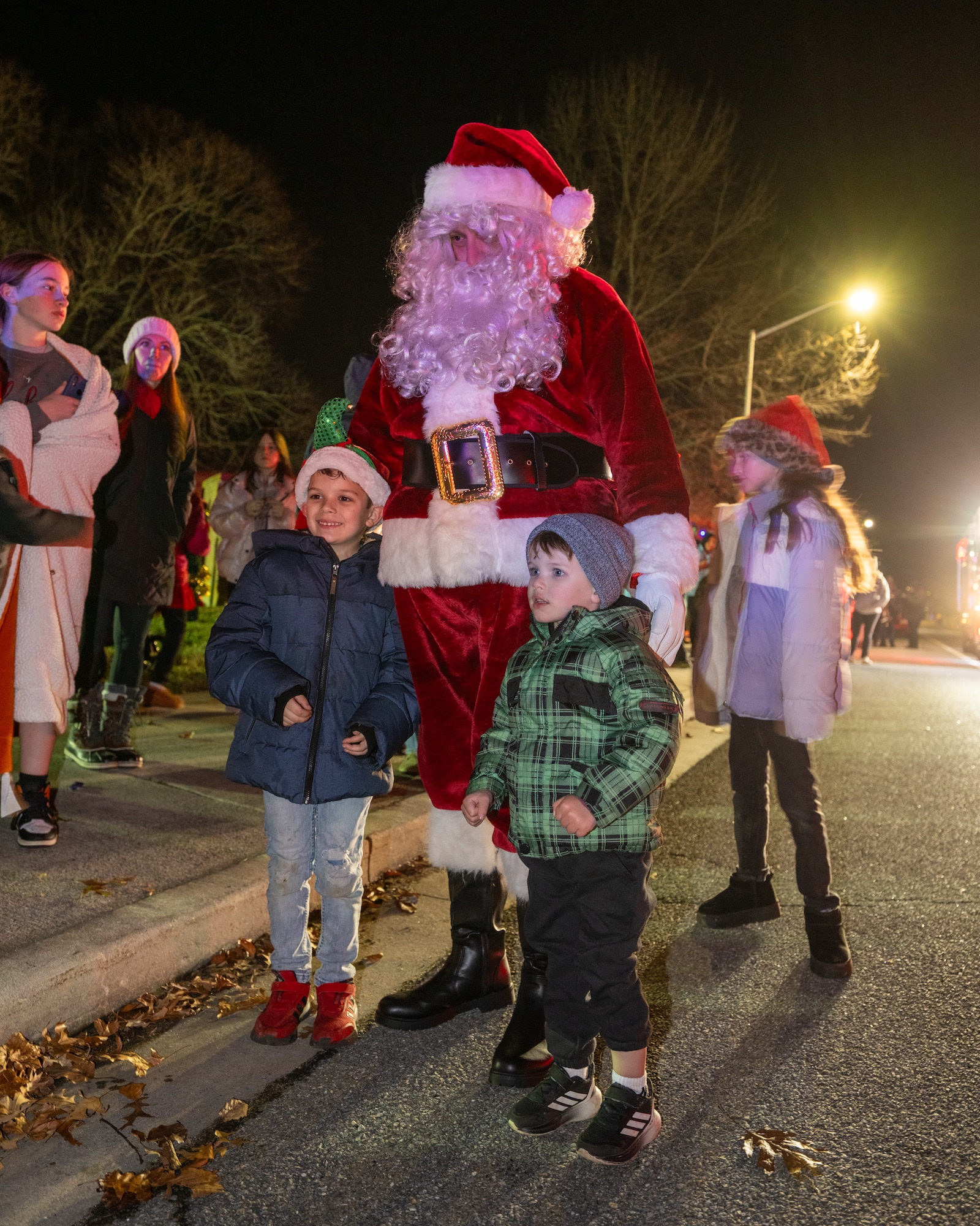 Santa Claus arrives and greets Team Dover families during the annual holiday parade at Dover Air Force Base, Delaware, Dec. 1, 2025. The annual celebration included a holiday parade and tree lighting ceremony. (U.S. Air Force photo by Mauricio Campino)