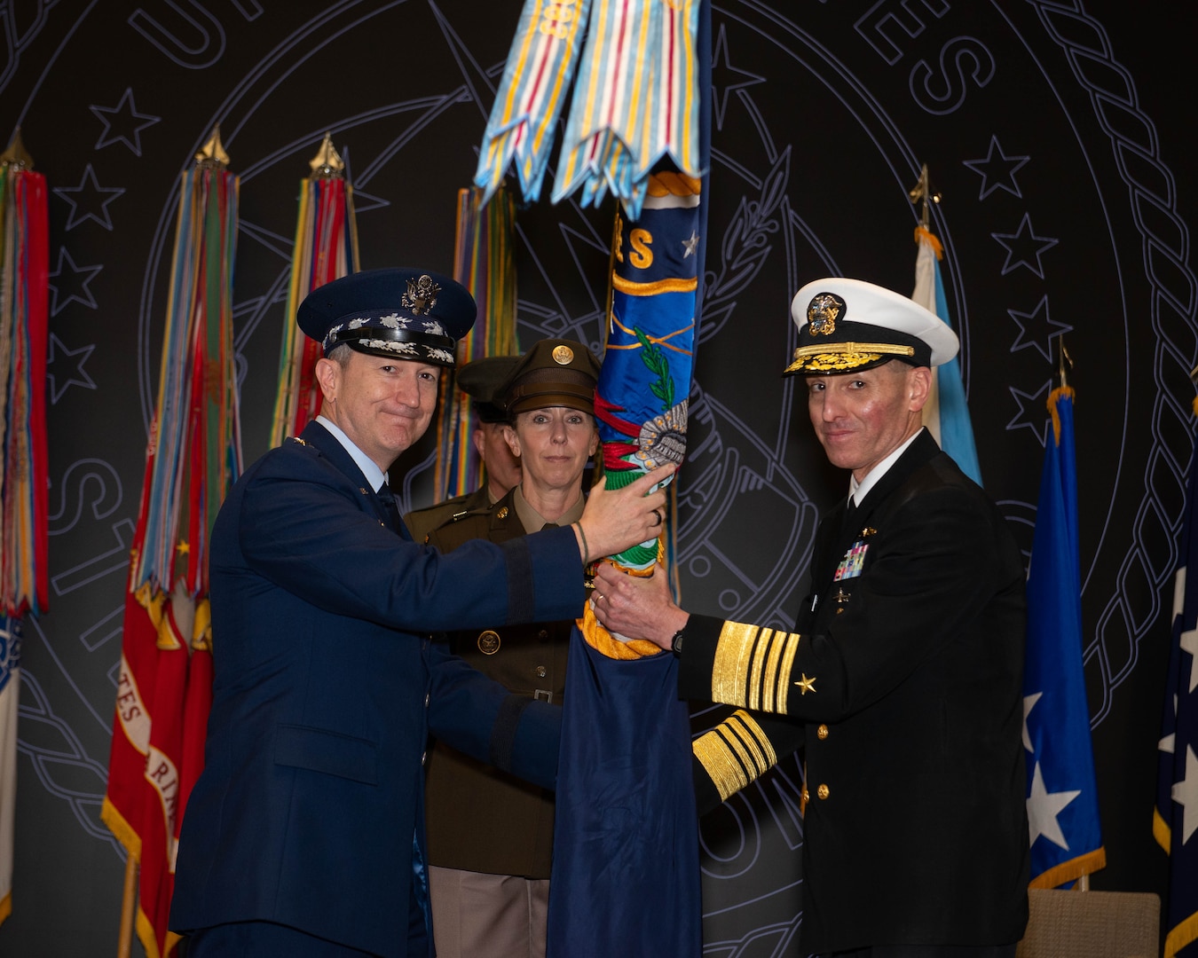 Chairman of the Joint Chiefs of Staff Gen. Dan Caine presents command of U.S. Strategic Command to Adm. Rich Correll on behalf of the President during a change of command ceremony in the USSTRATCOM.