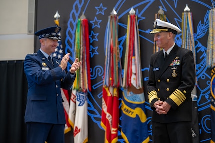 Chairman of the Joint Chiefs of Staff Gen. Dan Caine congratulates Adm. Rich Correll on his assumption of command of U.S. Strategic Command