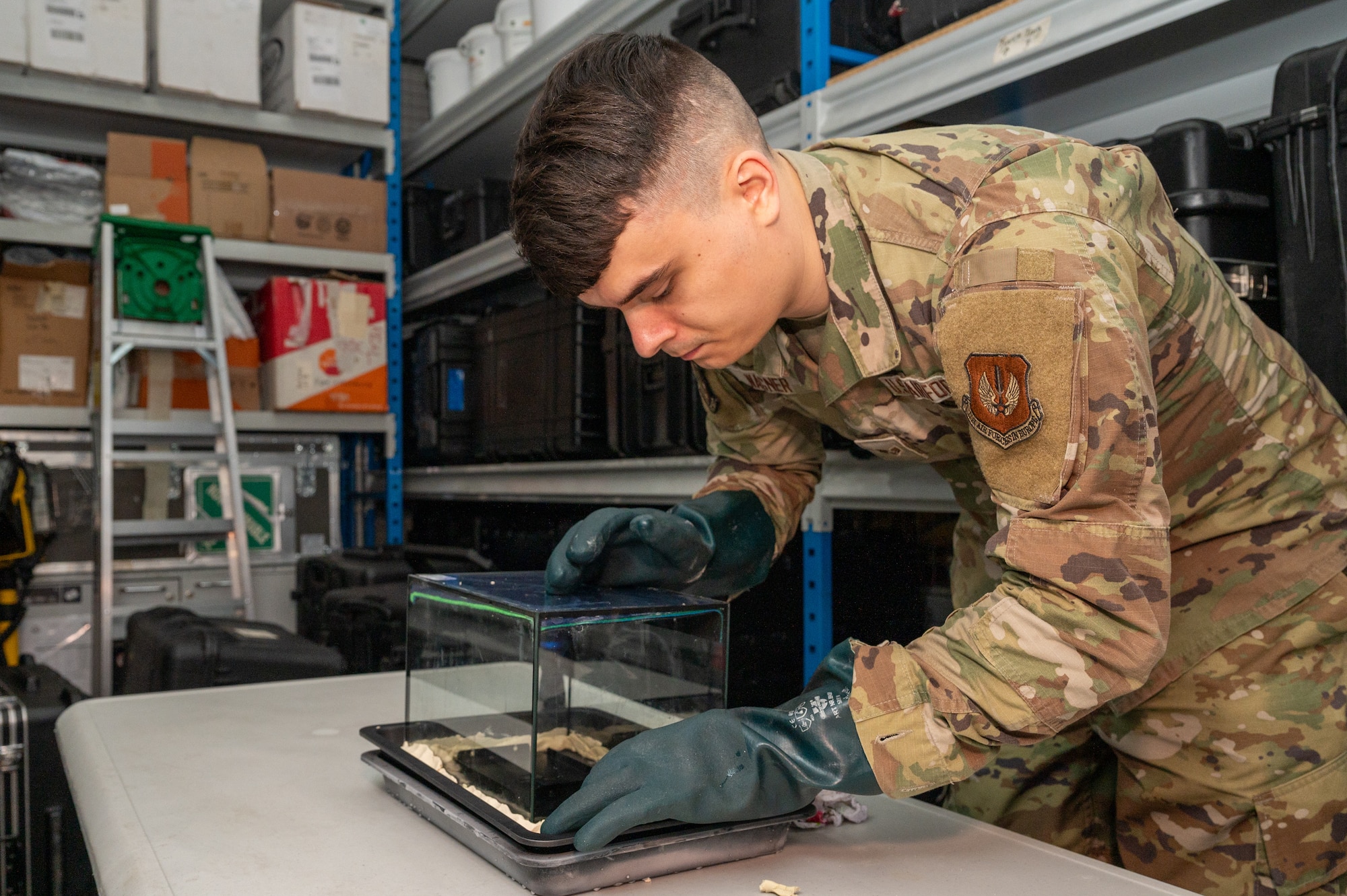 U.S. Air Force Senior Airman Brandon Wagner, 86th Operational Medical Readiness Squadron bioenvironmental engineering technician, puts in place a radiation source for a cloud chamber demonstration at Ramstein Air Base, Germany, Nov. 24, 2025.