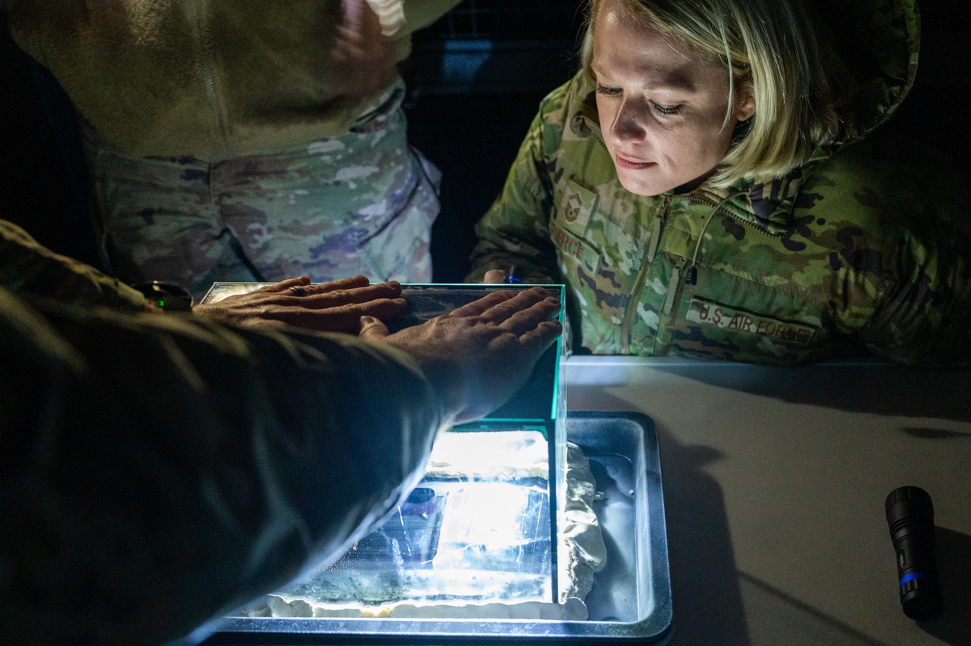 U.S. Air Force Senior Master Sgt. Victoria Pierce, 86th Operational Medical Readiness Squadron senior enlisted leader, observes the demonstration of a radiation cloud  chamber at Ramstein Air Base, Germany, Nov. 24, 2025.