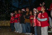 A photo of several children singing.