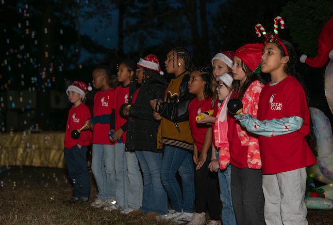 A photo of several children singing.