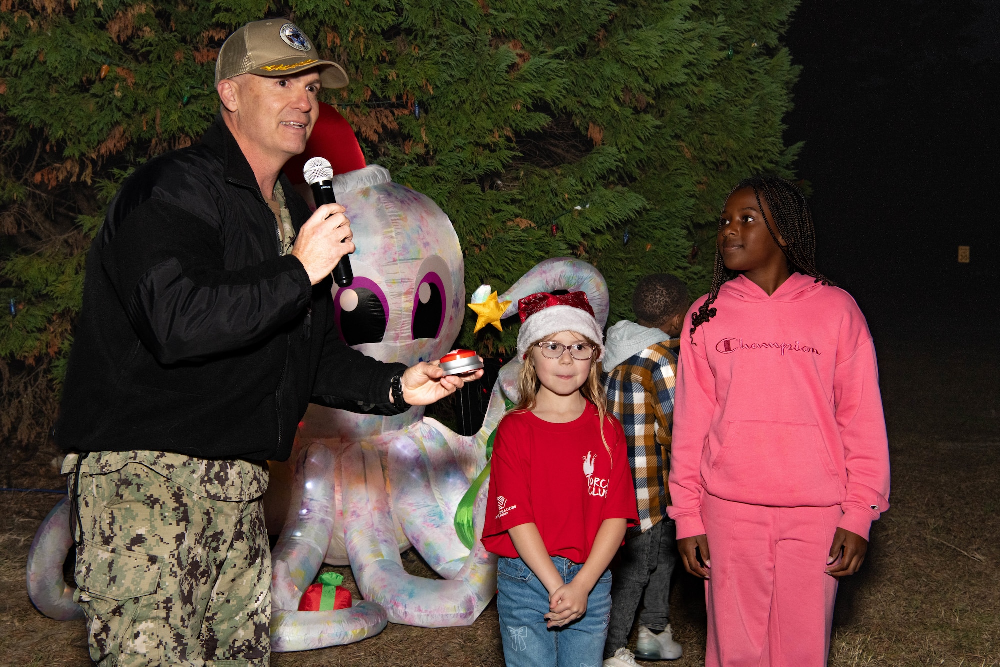 A photo of several people preparing to press a button.