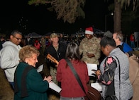 A photo of several people singing.