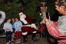 A photo of a family taking a photo with Santa