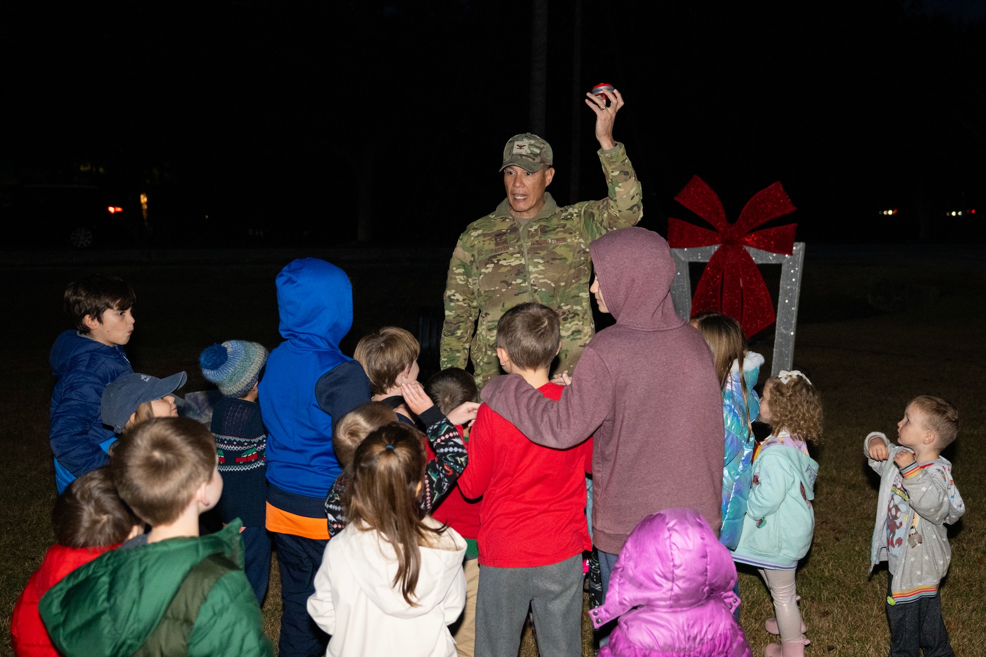 A photo of several people getting ready to press a button.
