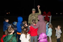 A photo of several people getting ready to press a button.