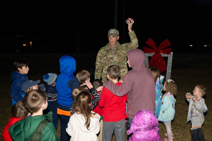 A photo of several people getting ready to press a button.