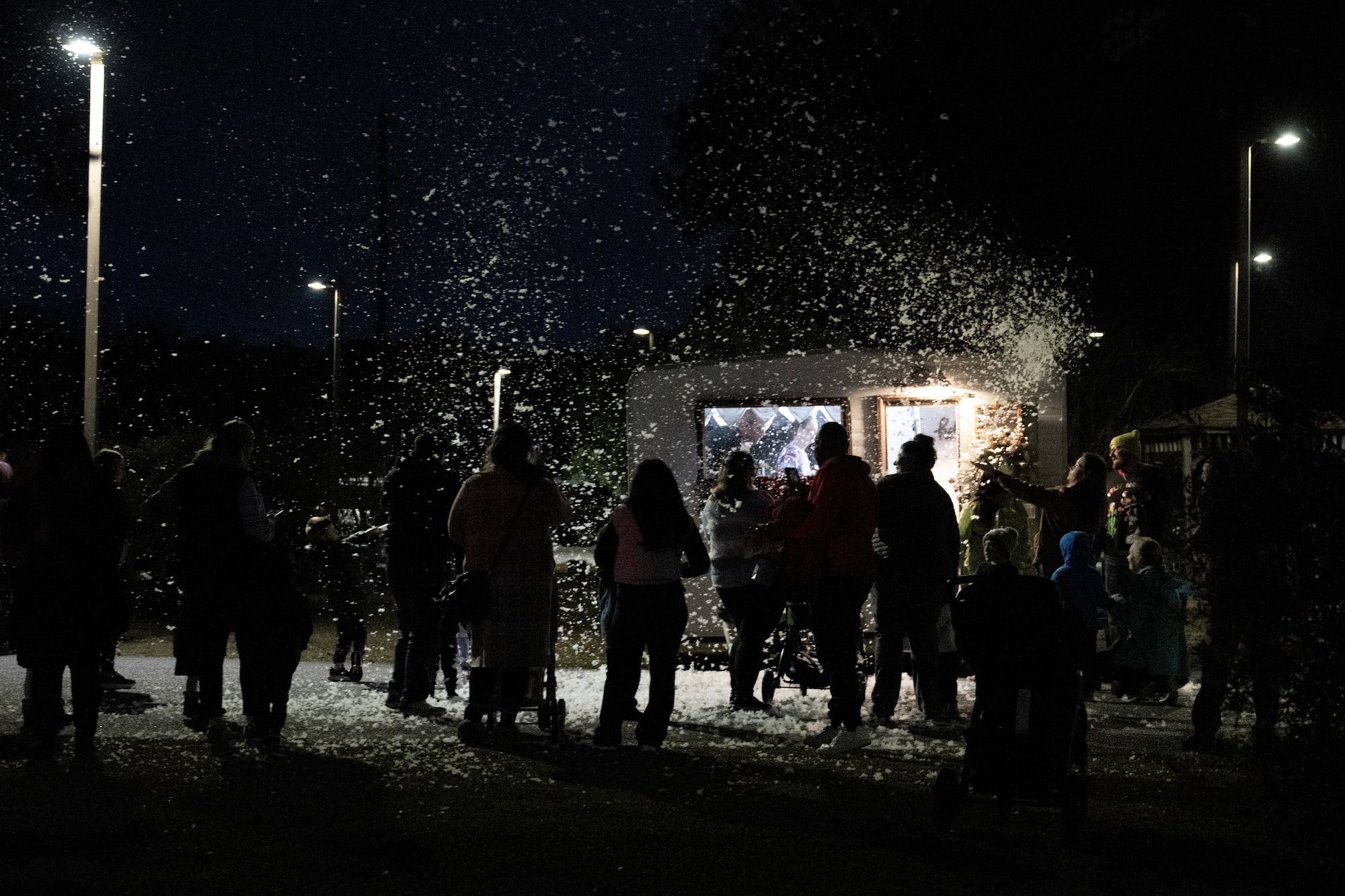 A photo of several people looking at snow.