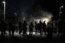 A photo of several people looking at snow.